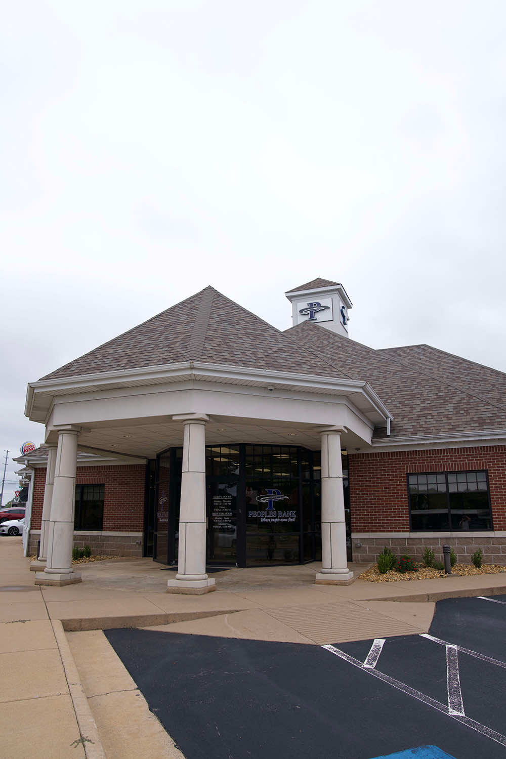 Exterior of a Peoples Bank branch with a columned, covered entrance