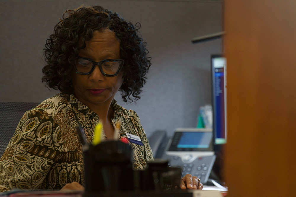 A Peoples Bank employee working at her desk in the branch