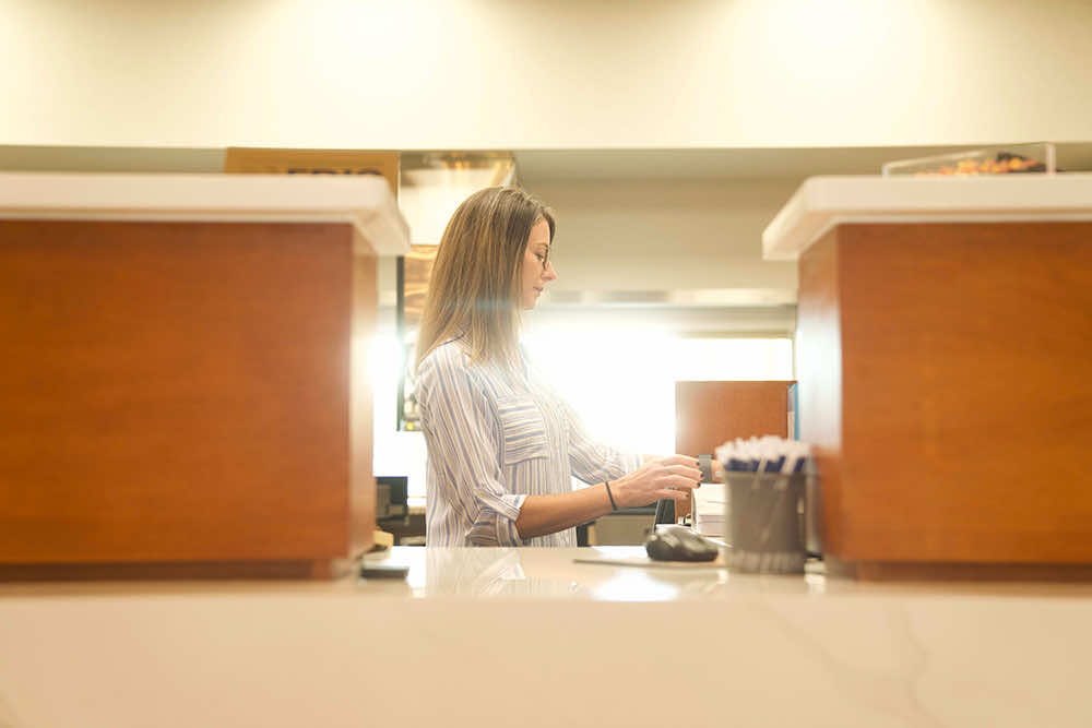 A Peoples Bank teller working behind the counter