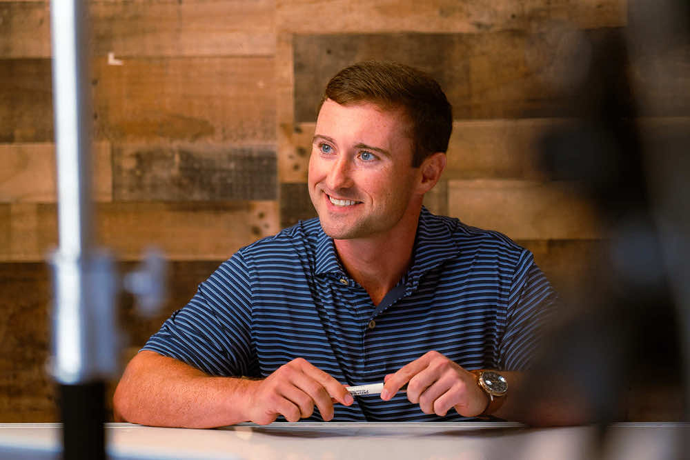 A Peoples Bank lender smiling during a conversation across the table